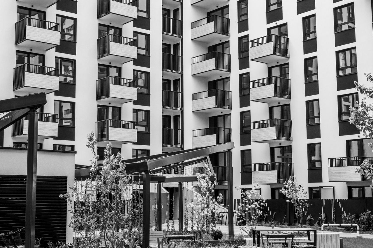The Art of Drawing Readers In: Your attractive post title goes here Contemporary urban apartment building with balconies and courtyard, black and white.
